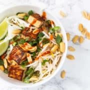 Bowl of vegan pad Thai noodles with tamarind sauce.