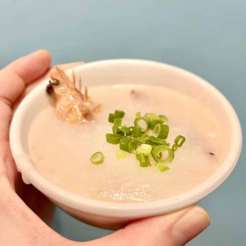 A bowl of shrimp congee toped with fresh green onions.