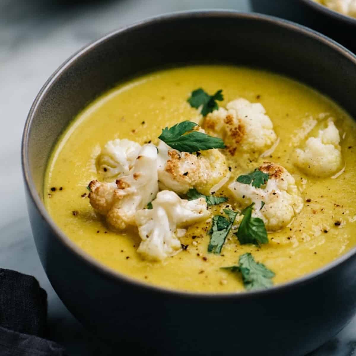 A bowl of cauliflower soup with turmeric.