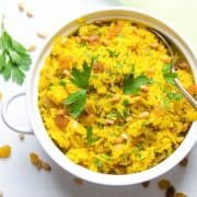 Yellow turmeric pilaf in a white bowl.