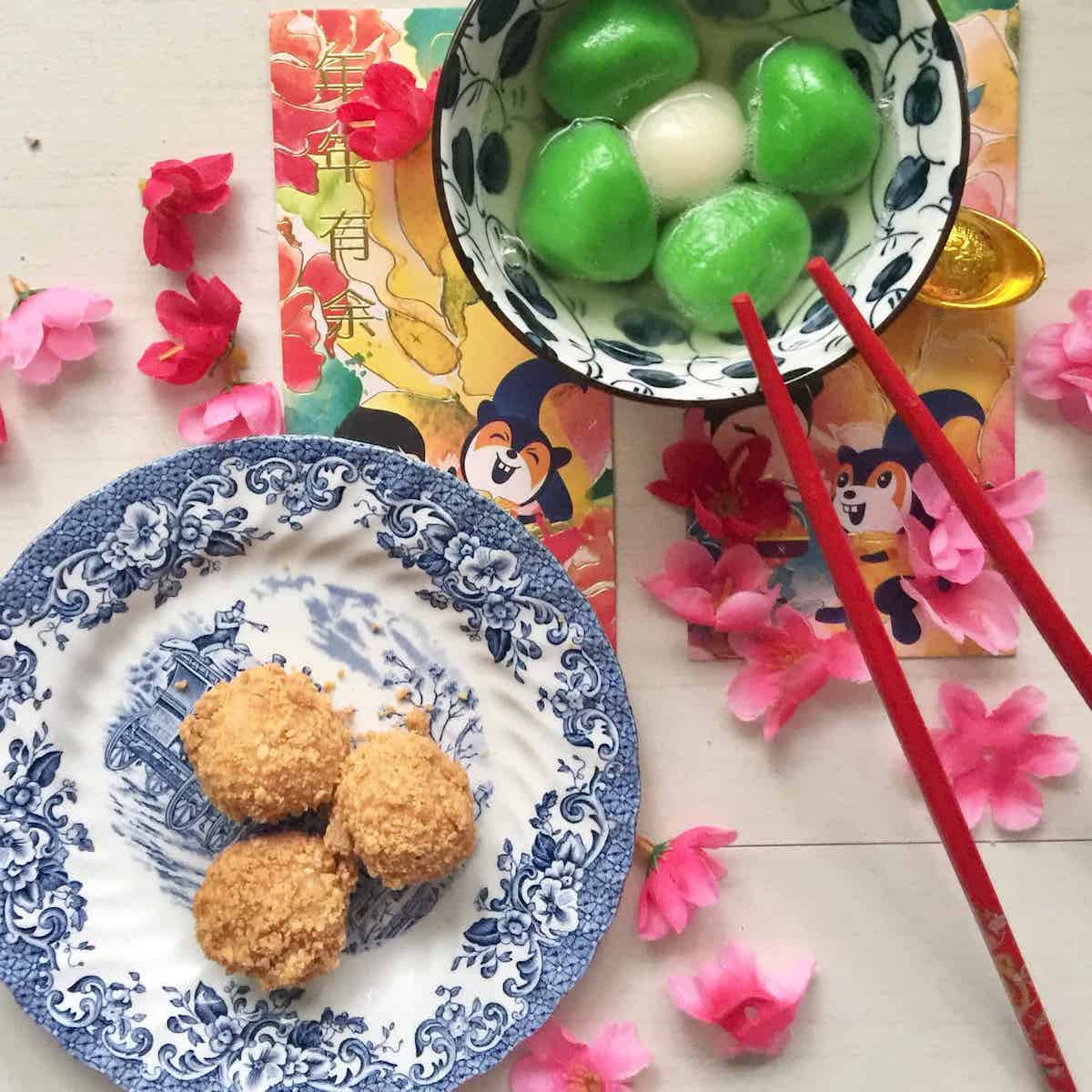 A bowl of colourful tang yuan and a plate of dry glutinous rice dumplings.