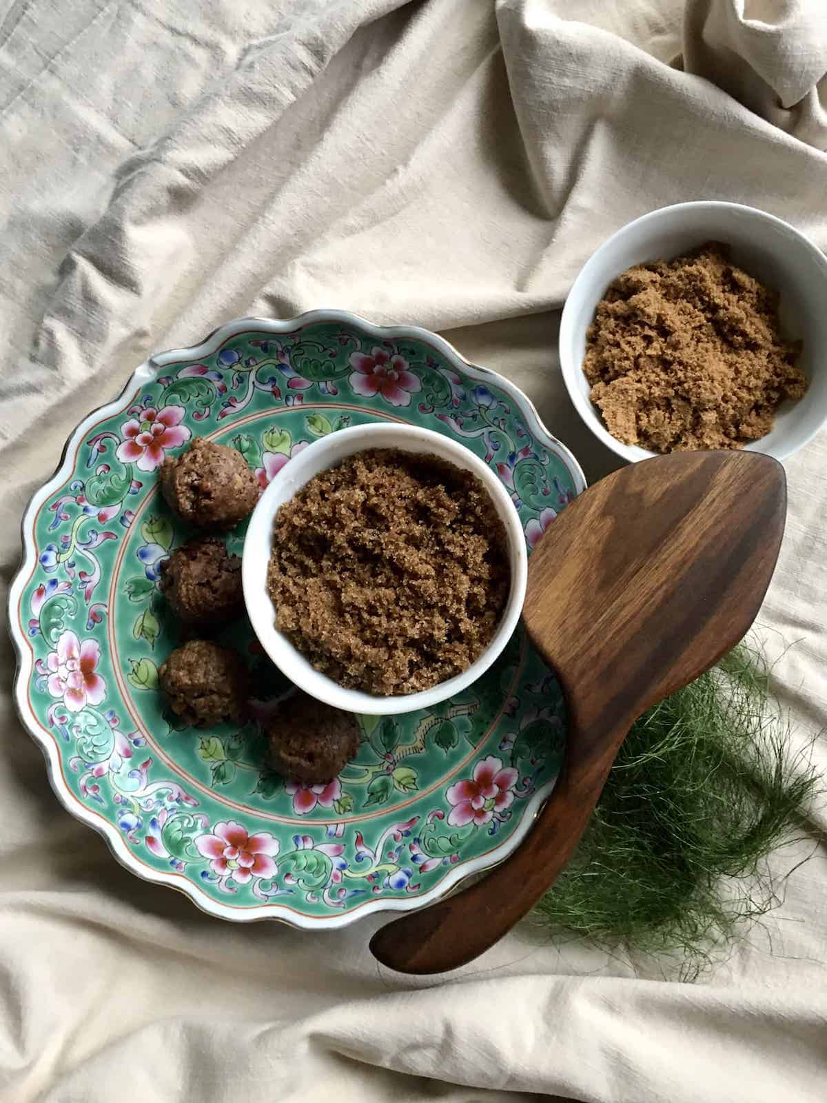 Bowl of homemade light brown sugar next to a bowl of shopbought light brown sugar