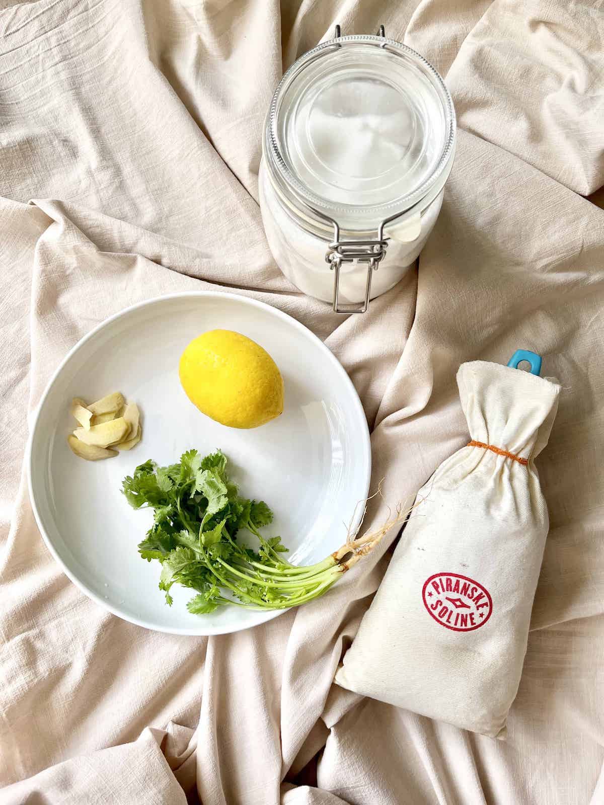 The ingredients for coriander chutney: coriander, lemon, ginger, salt and sugar.
