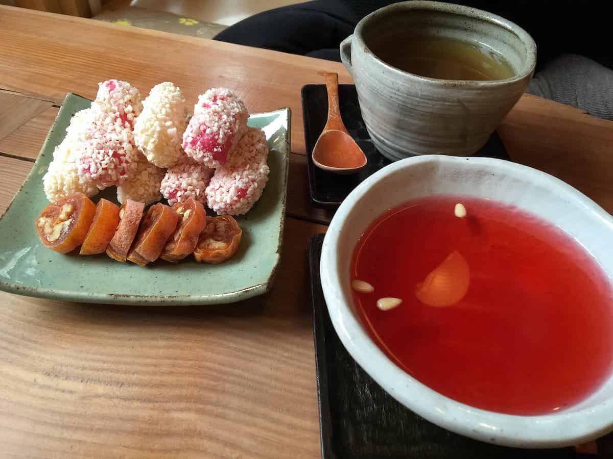 A selection of traditional Korean snacks with Omija tea.