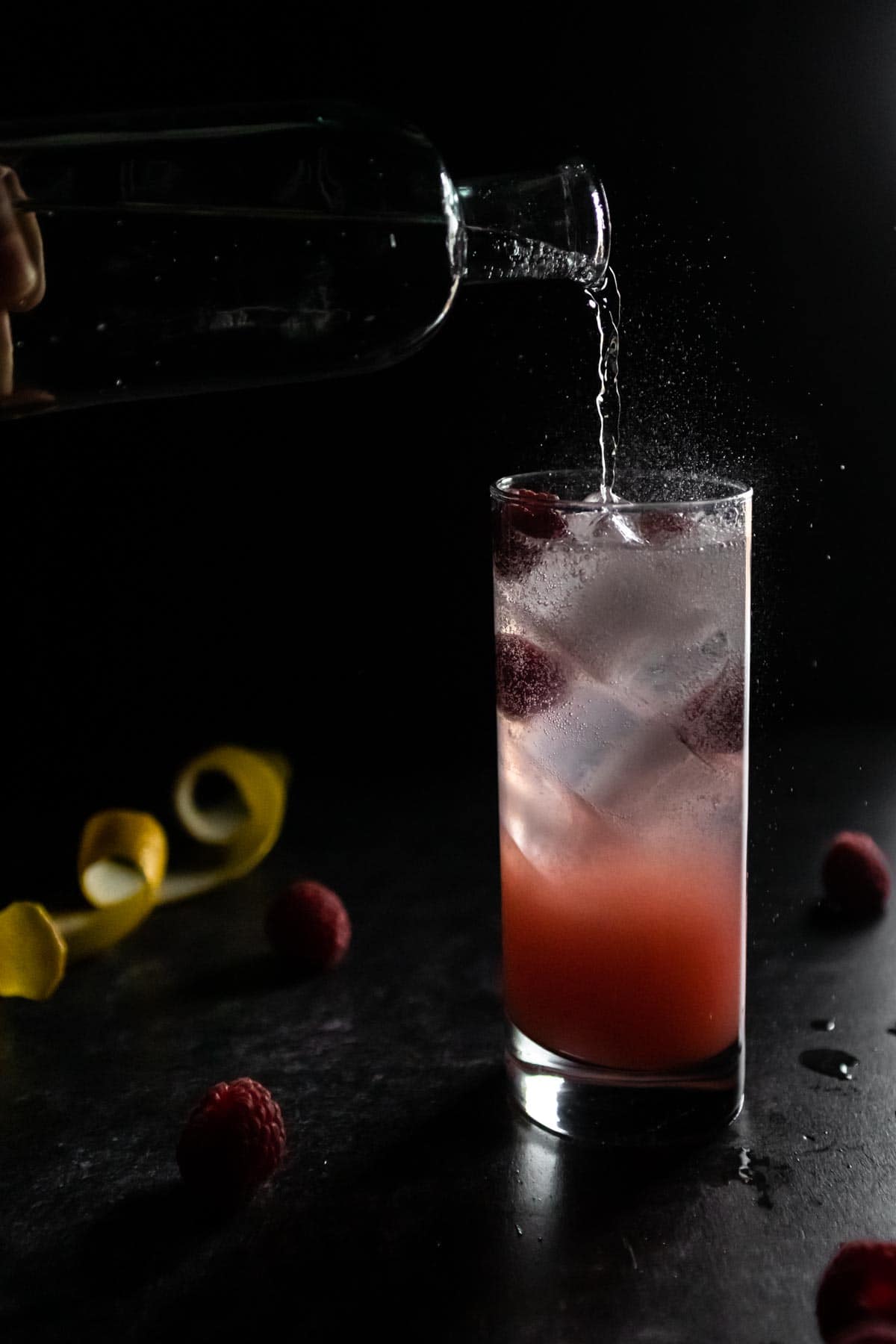 A moody shot of a cocktail made with canned lychees.