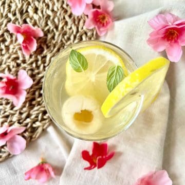 Overhead shot of lychee tea with lemon and mint.