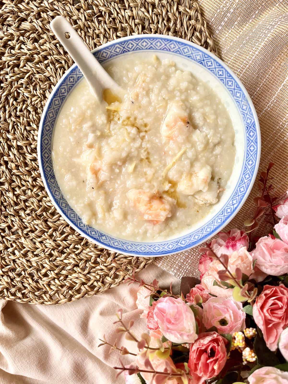 A bowl of Cantonese jook with mixed seafood in it.