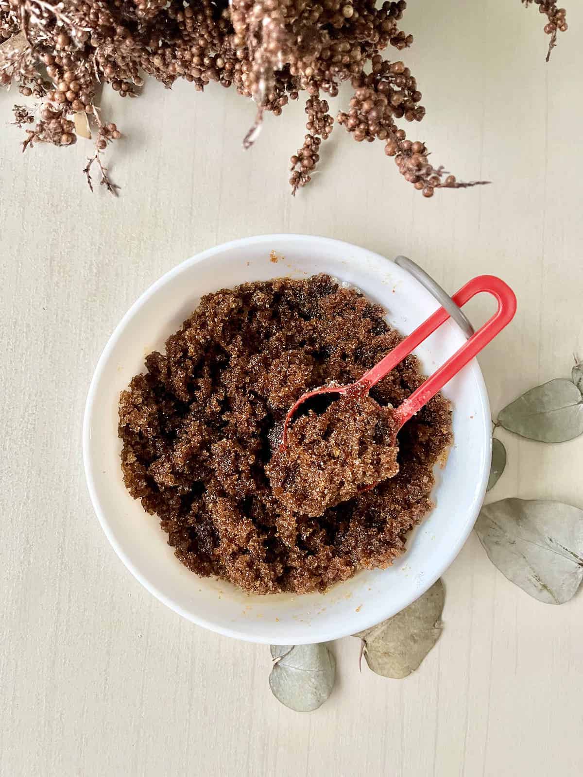 A bowl of homemade dark brown sugar made from blackstrap molasses.