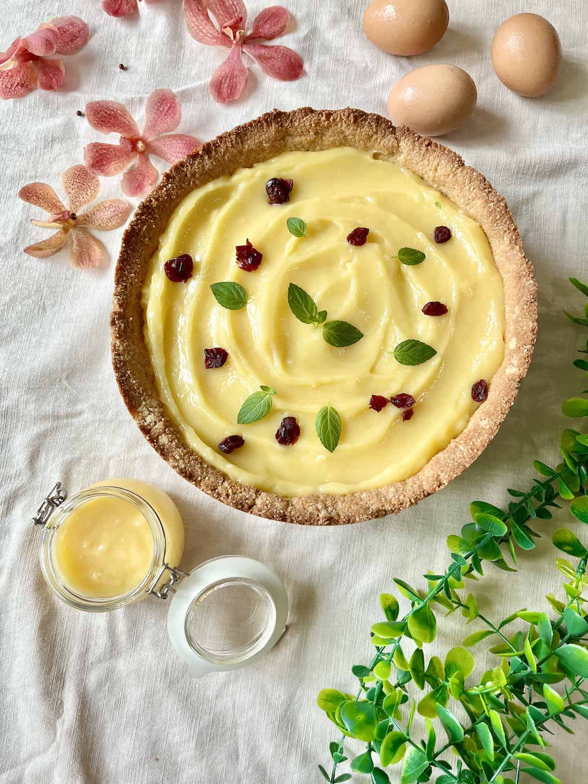 A tart with calamansi lime curd filling and dried fruits on top.