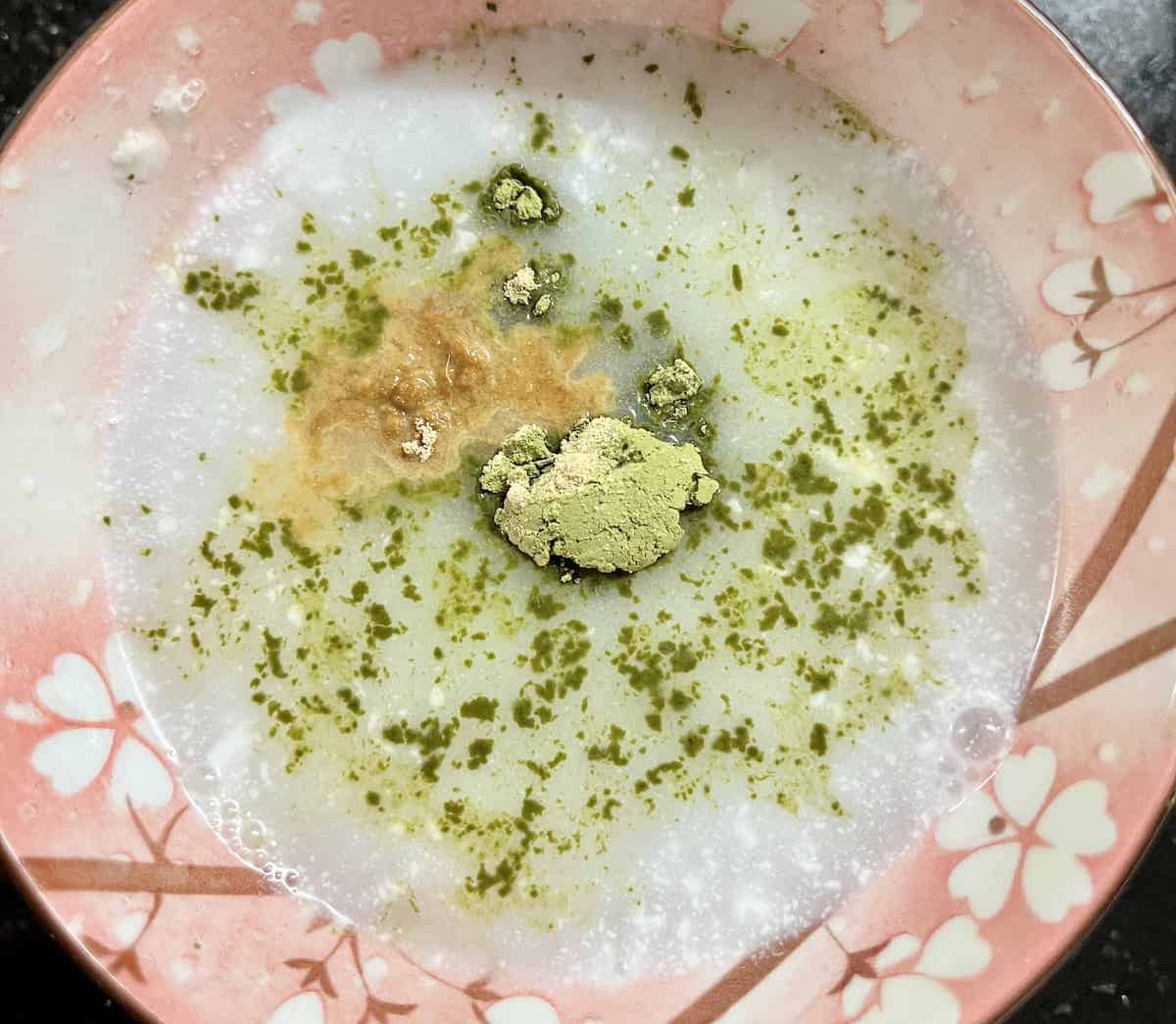 Matcha powder and ginger powder mixed with water and coconut cream.