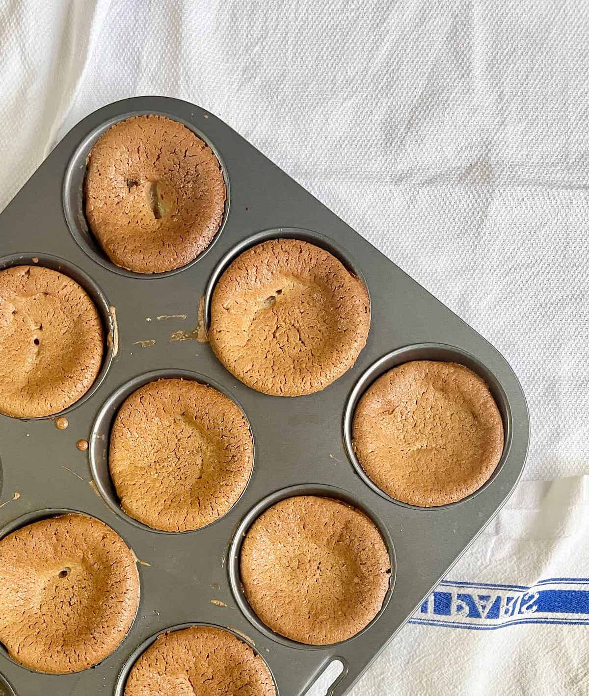 Green tea mochi muffins in a baking tray.