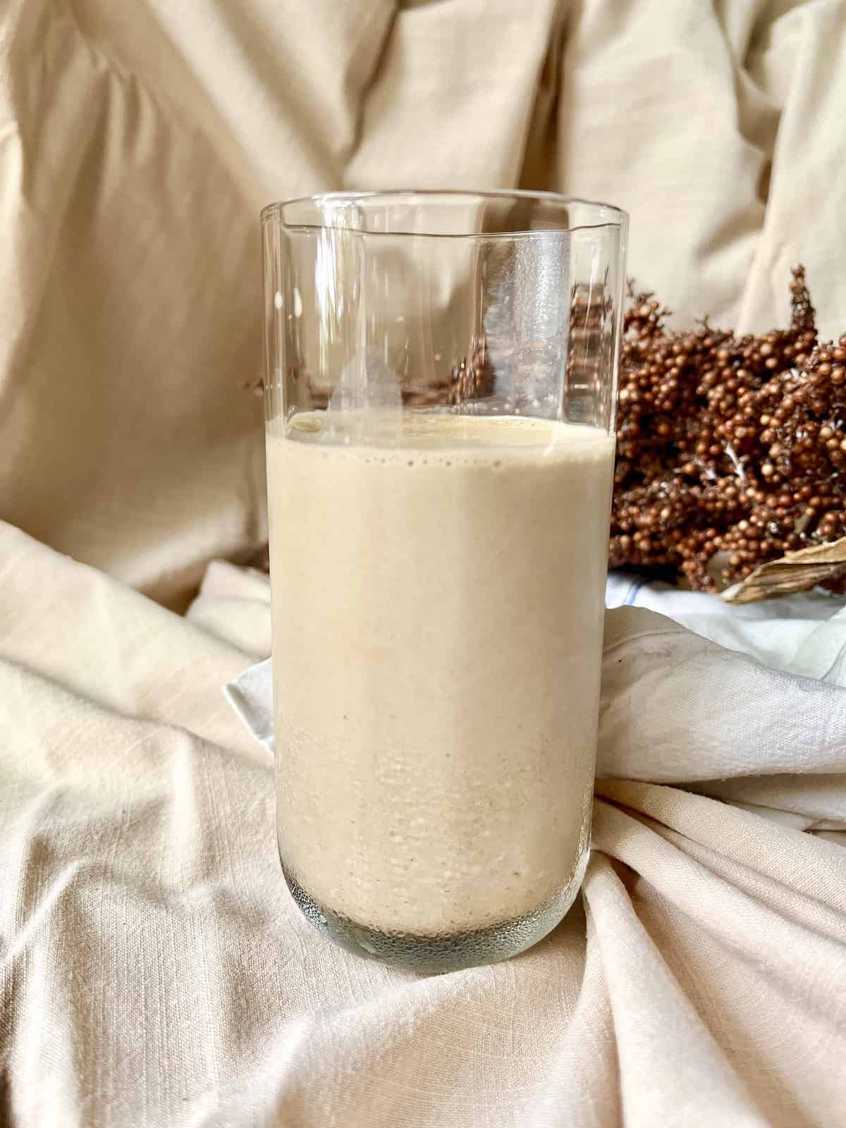 A glass of brown Hojicha cold tea latte.