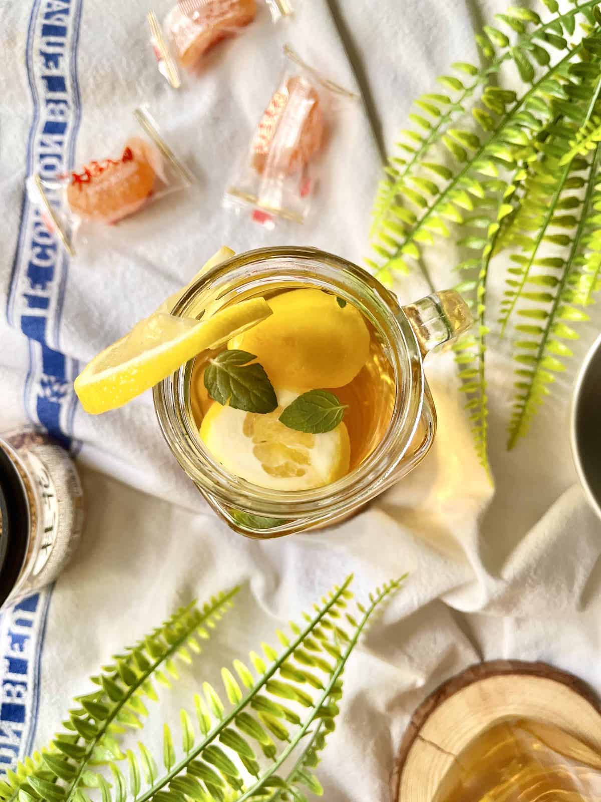 A glass of iced sweet tea on a white dishcloth.