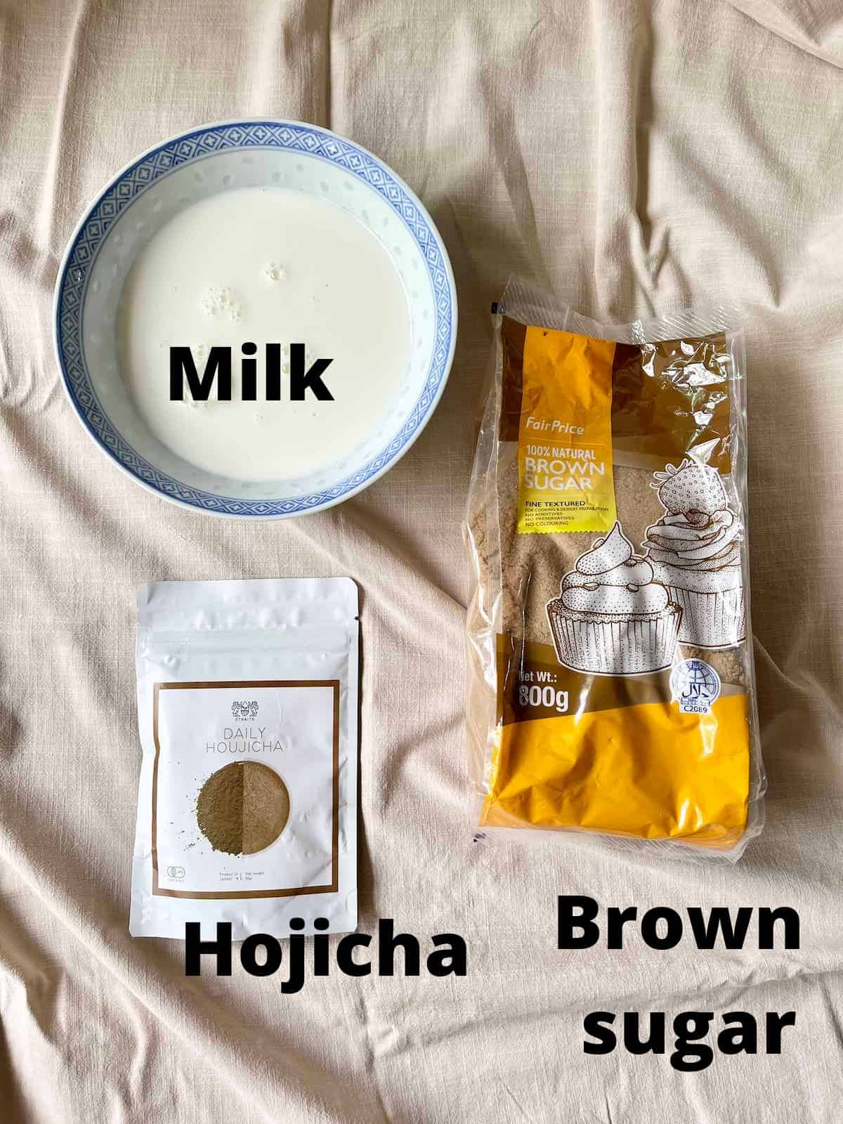 The 3 ingredients needed for homemade Hojicha Latte on a linen tablecloth.