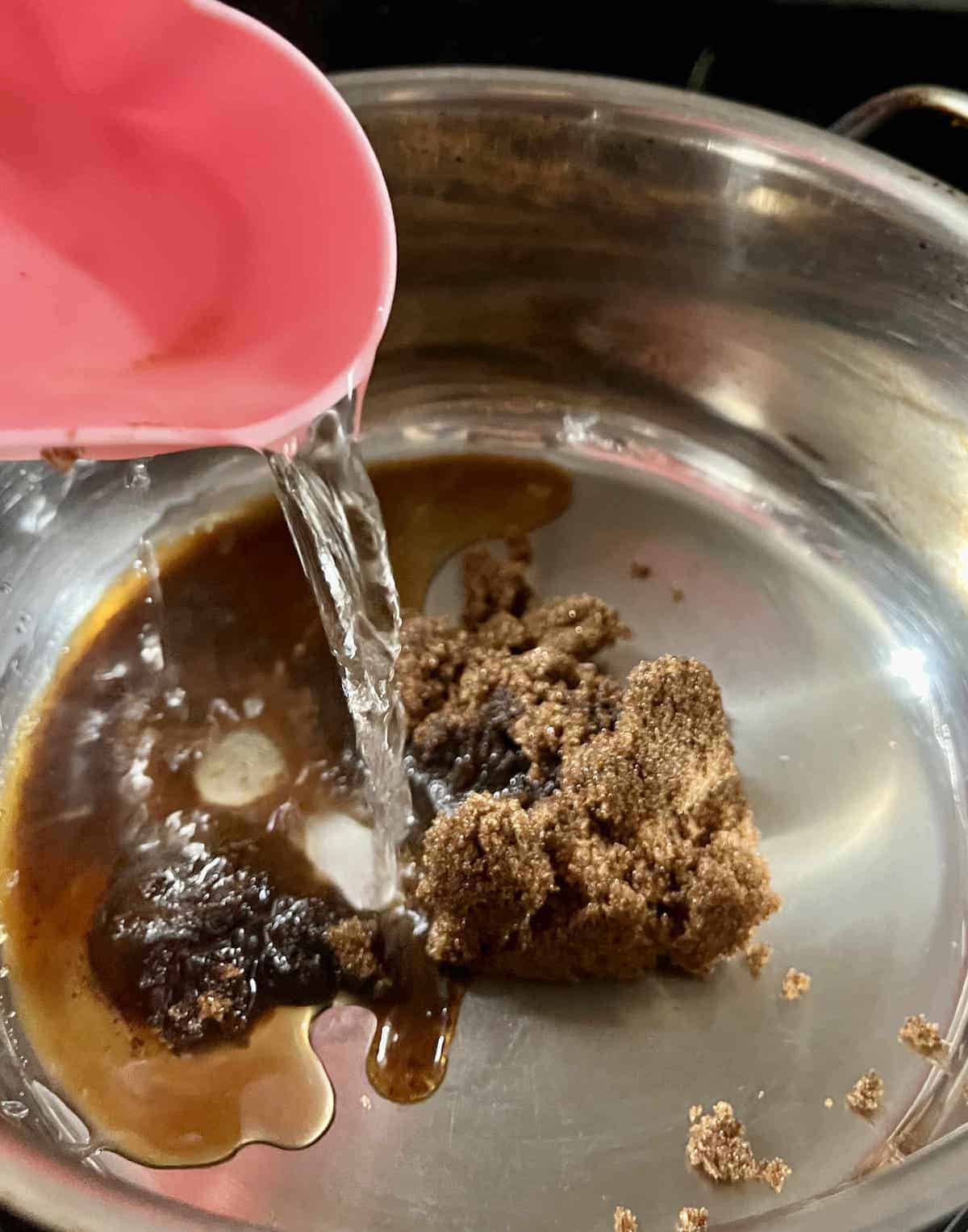 Melting brown sugar and water to make brown sugar syrup.