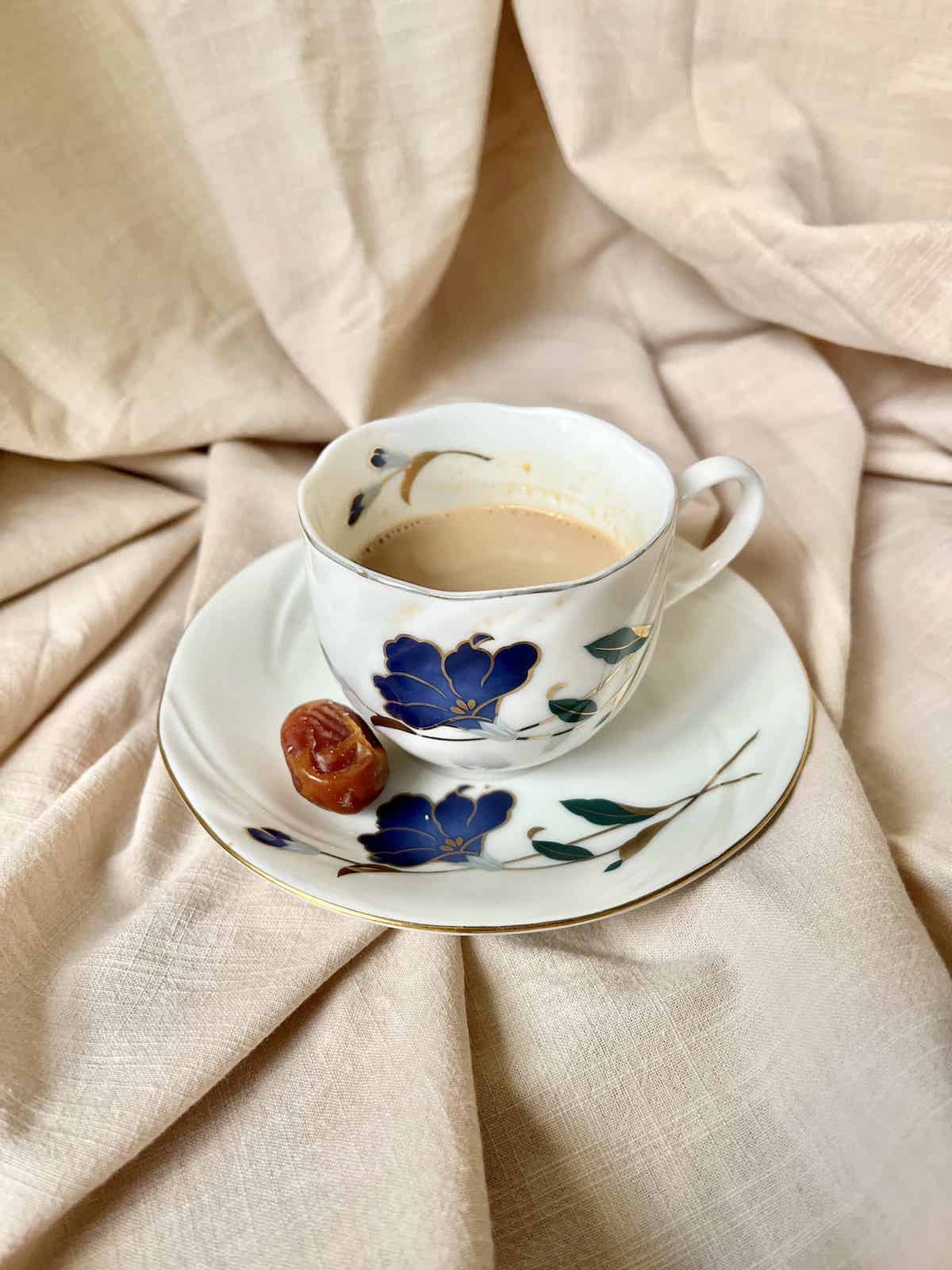 Milk Tea in a vintage cup on a beige tablecloth.