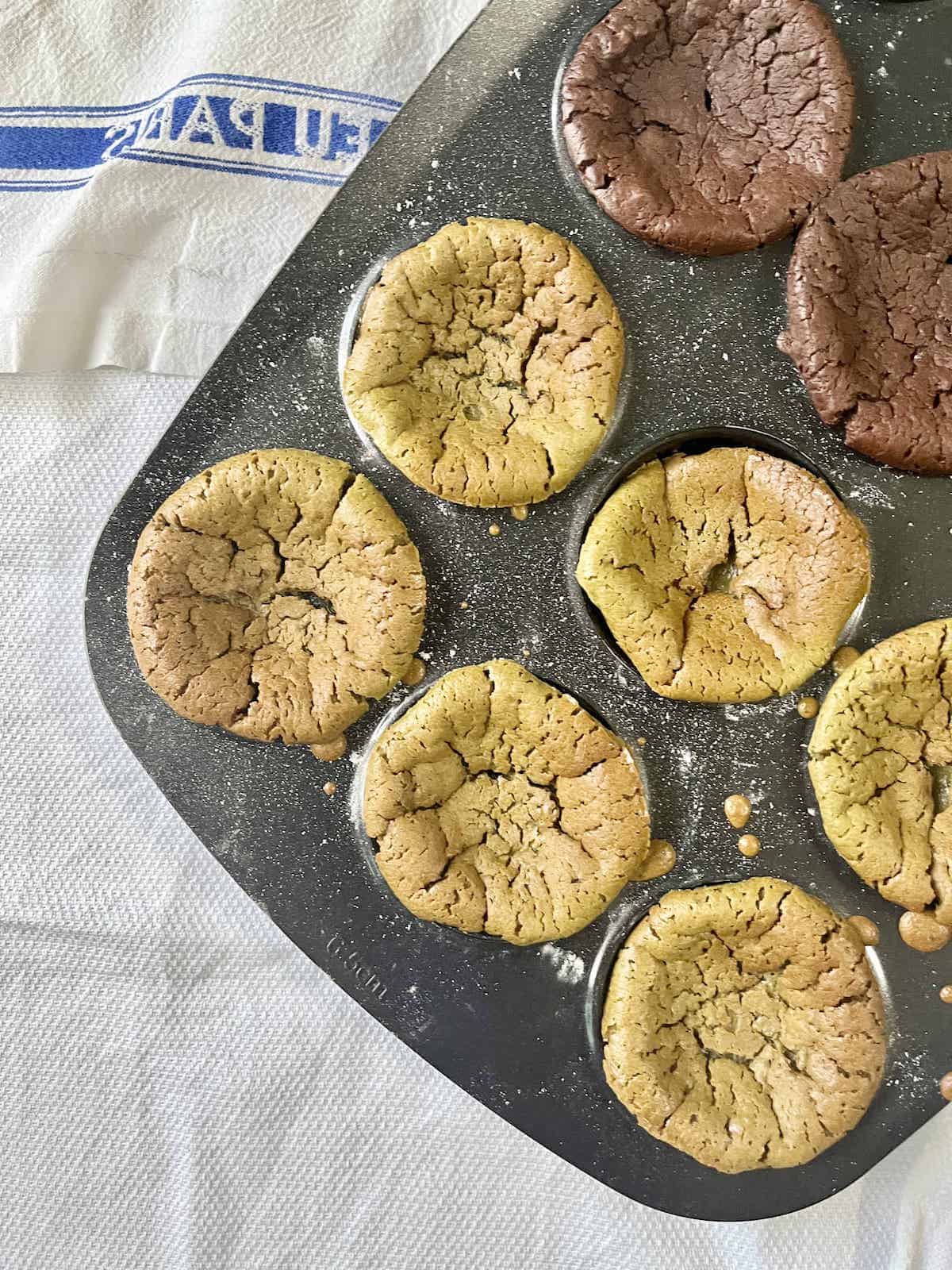 A tray of overbaked matcha and chocolate mochi muffins.