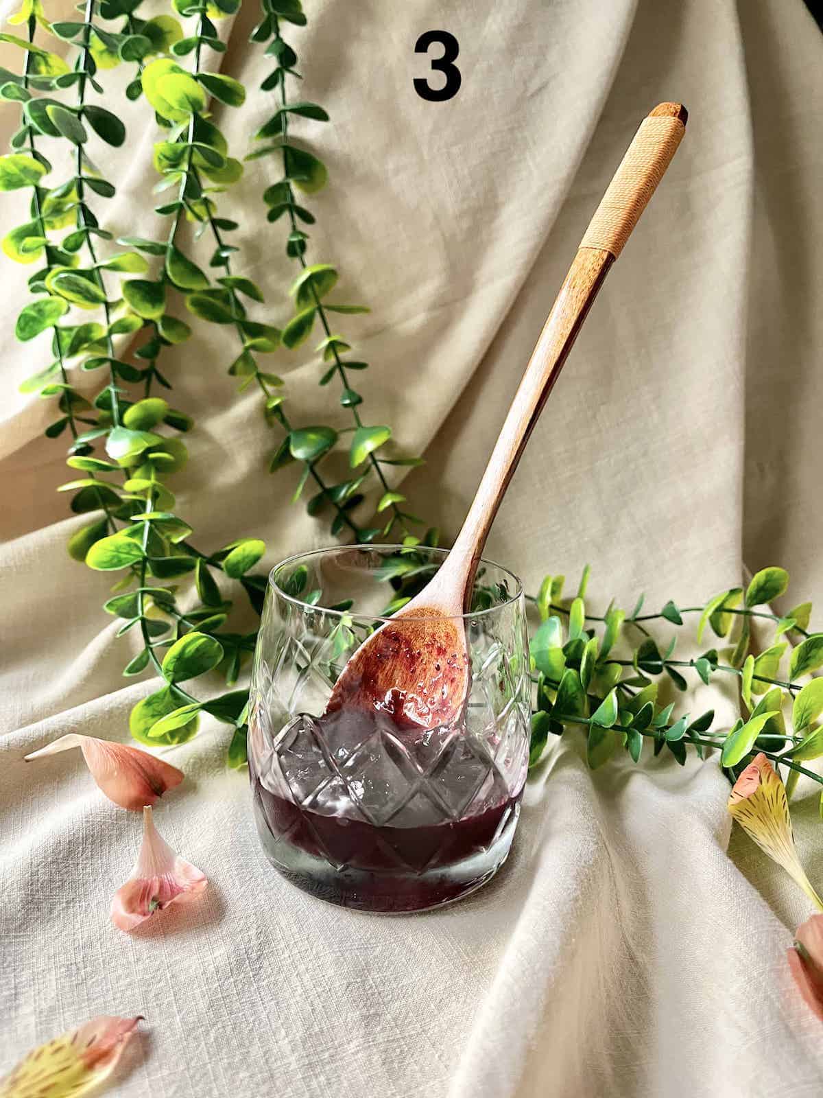 Blueberry compote scooped into a glass cup.