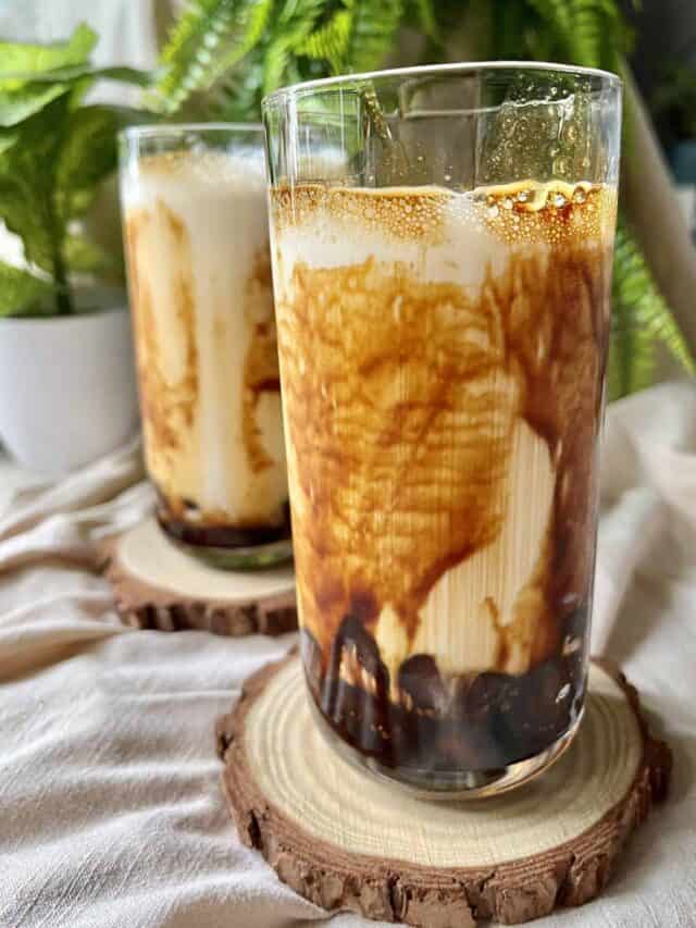 2 glasses of homemade Taiwanese tiger milk tea with brown sugar streaks on the glass.