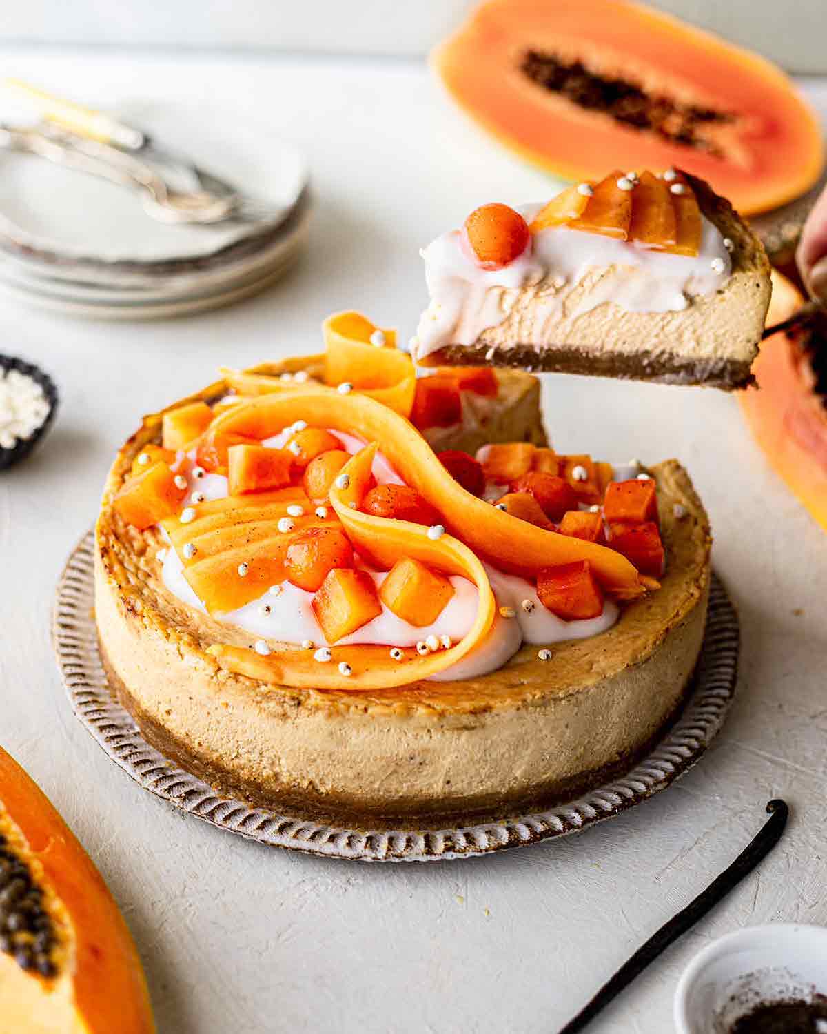 A side shot of a beautiful cheesecake made with papaya.
