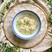 Chinese wontons in a bowl of clear chicken soup.