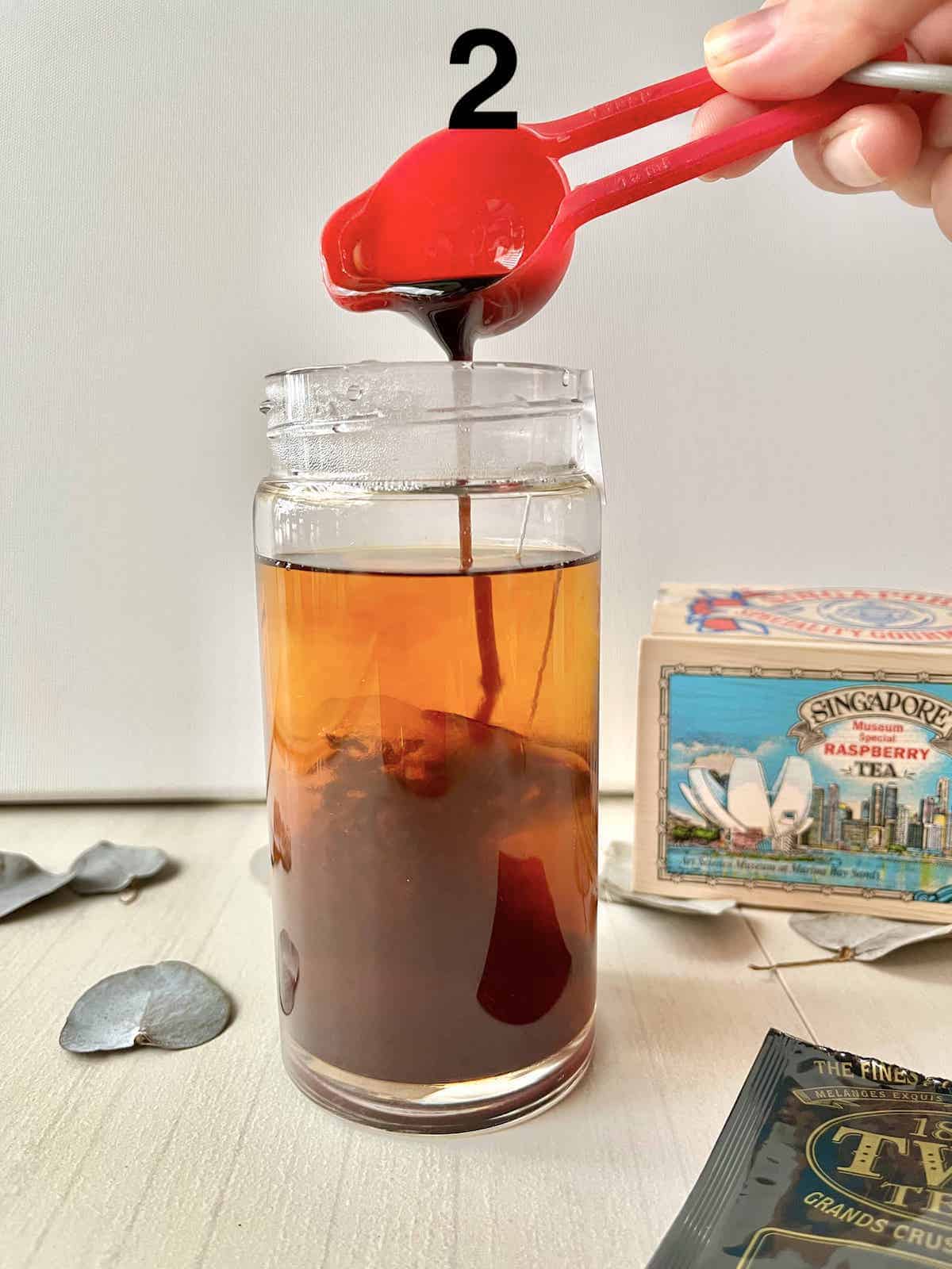 Adding spiced Chai Syrup to black tea.