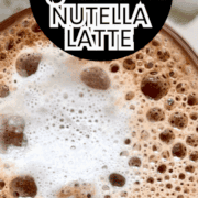 Overhead shot of frothy creamy Nutella latte with text on top.