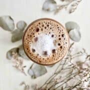 Overhead shot of a Nutella coffee with frothy milk foam on top.