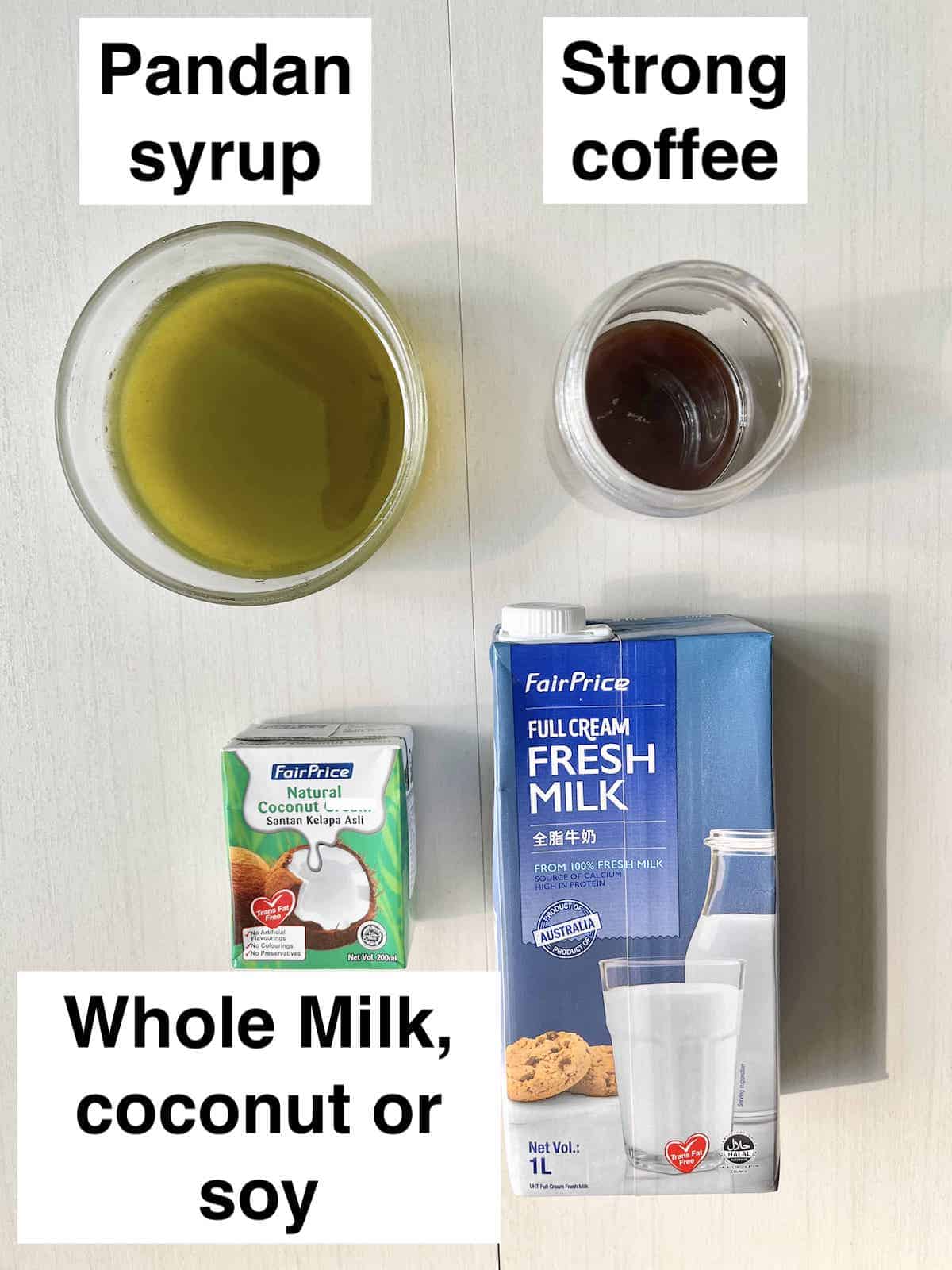 Pandan Syrup, coffee and milk next to each other on a cream background.