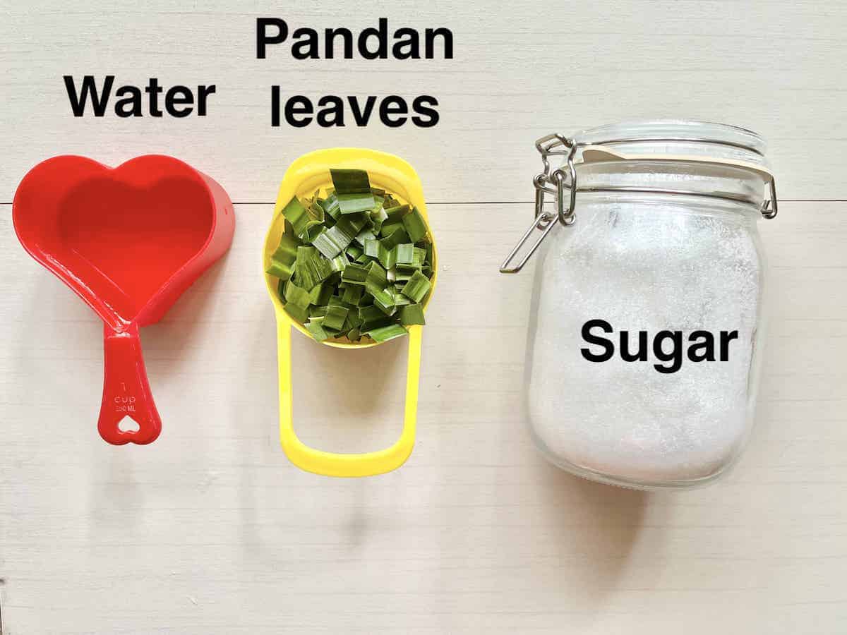 The 3 ingredients needed for homemade pandan syrup on a cream bakground.