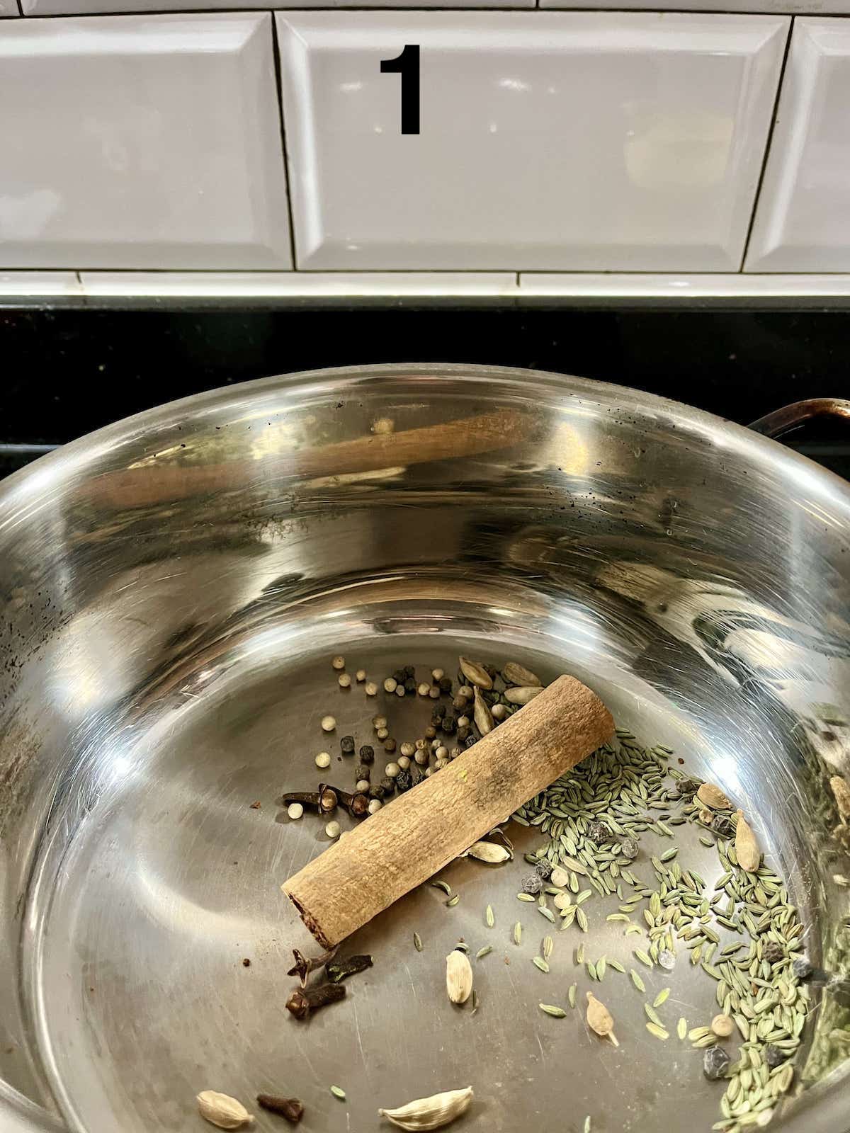 Masala Chai Tea spices, such as cinnamon, fennel seeds etc, being dry toasted in a pot.