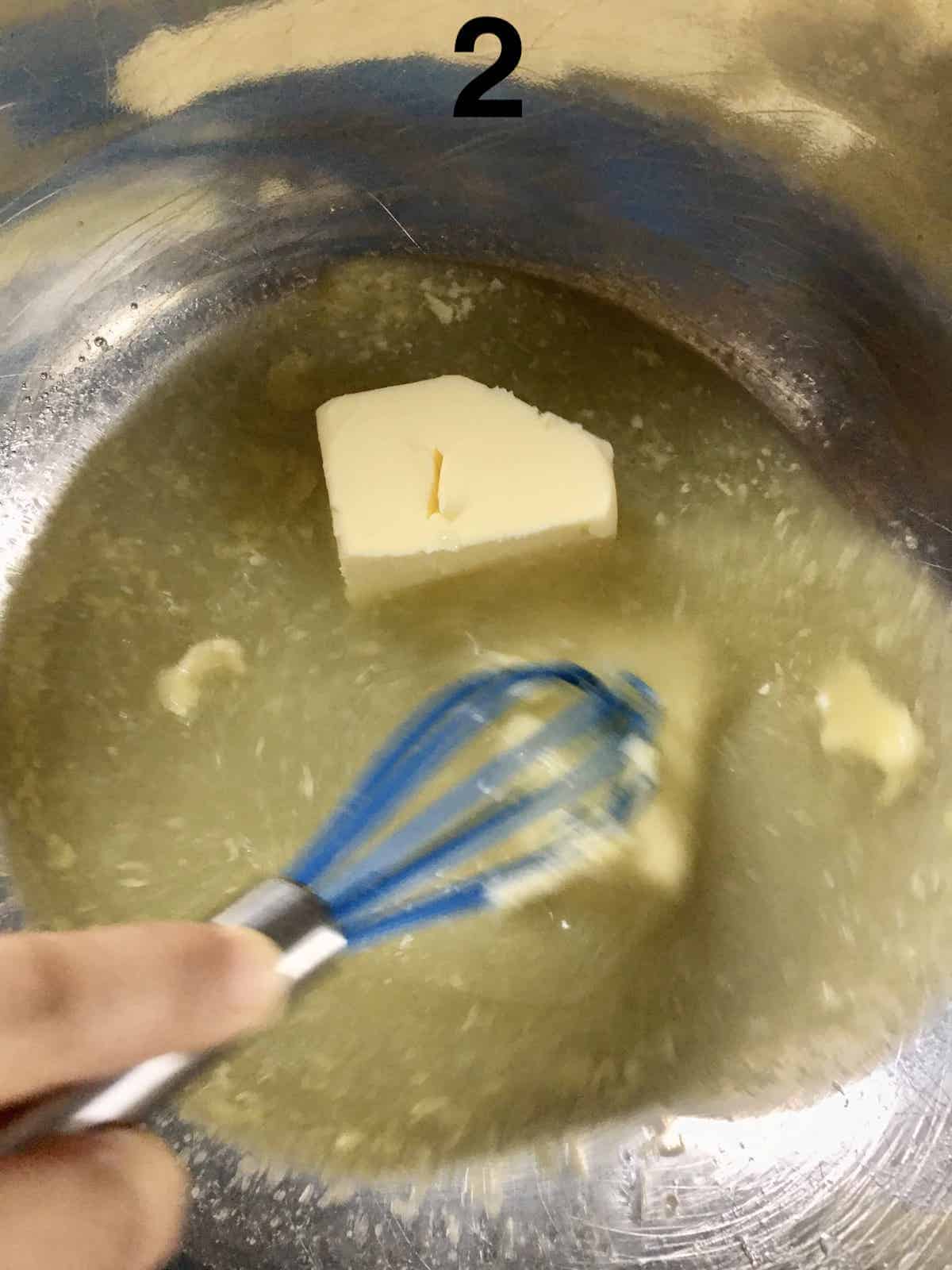 Whisking butter into a mixture of lime juice and sugar.