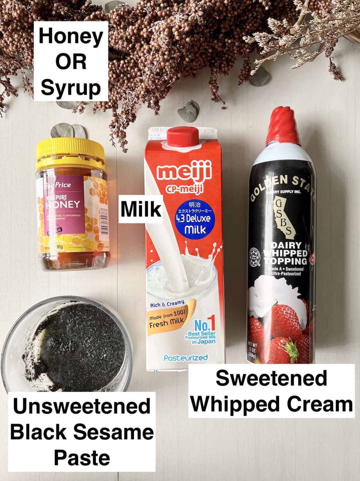 A bottle of honey, black sesame paste, milk and whipped cream next to each other.