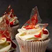 Close-up of a cupcake with a clear decoration that looks like bloody glass.