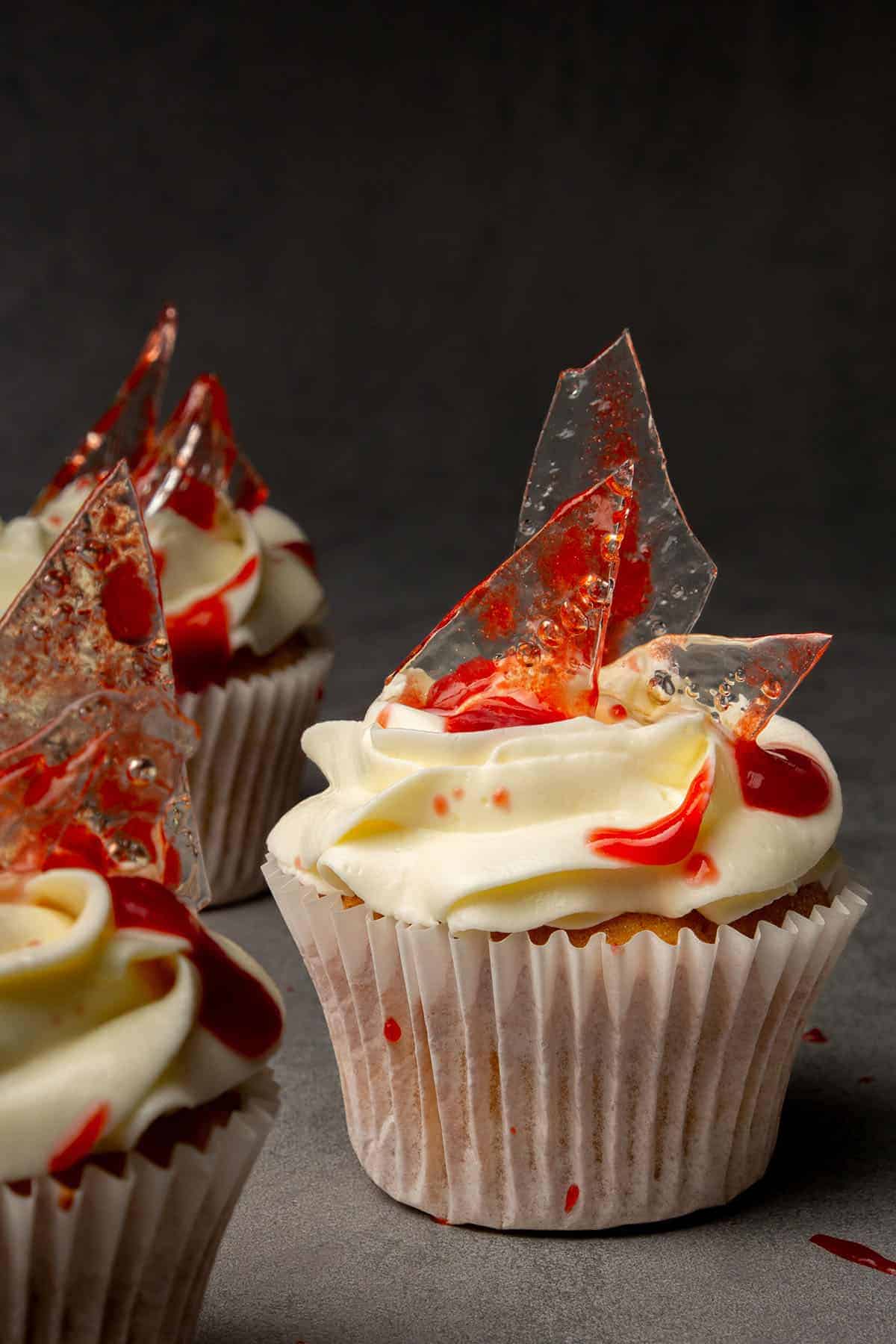 Close-up of a cupcake with a clear decoration that looks like bloody glass.
