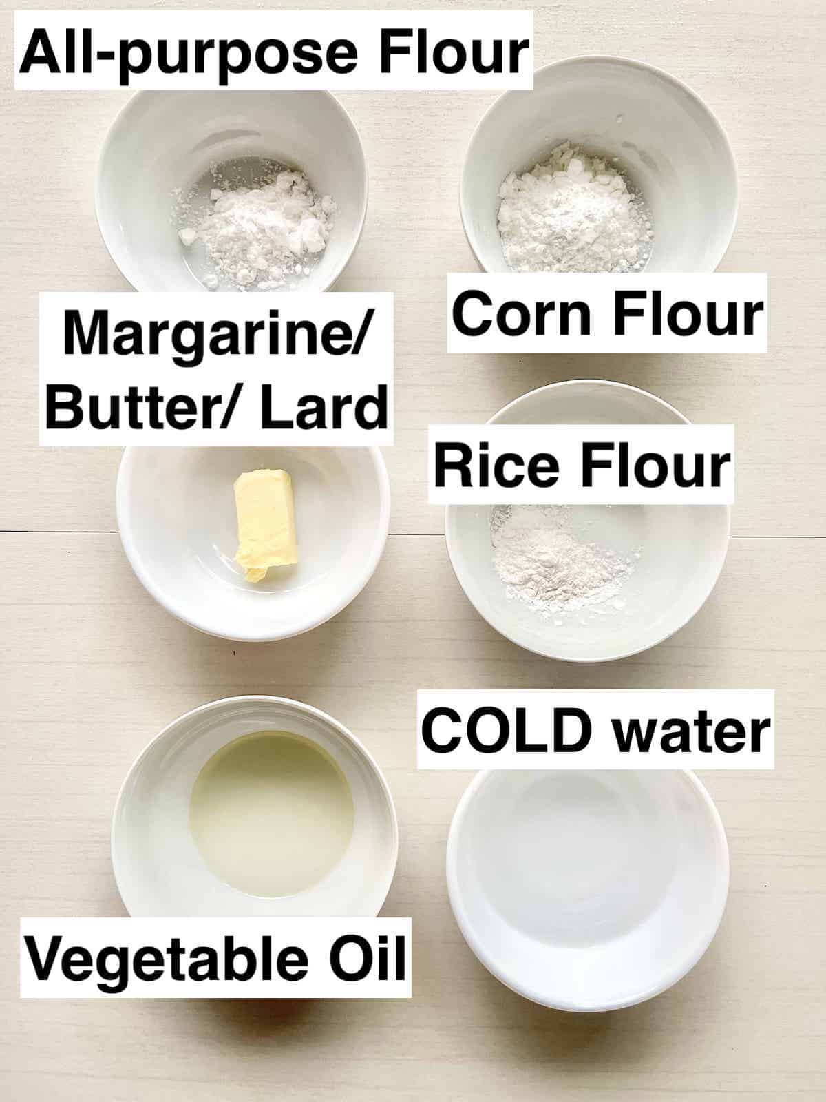 The ingredients for a crisp curry puff dough in white bowls.