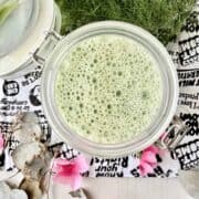 An oat milk matcha latte made in a mason jar that is very frothy!