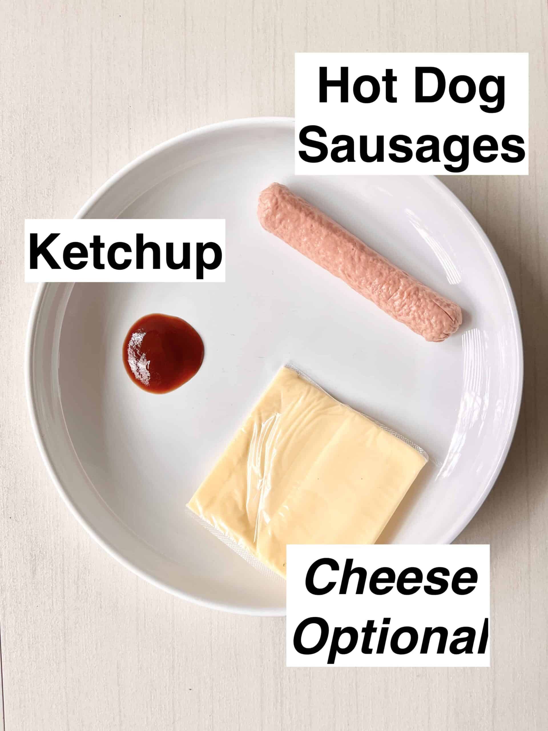 A boiled sausage, some ketchup and a slice of cheese on a white plate.