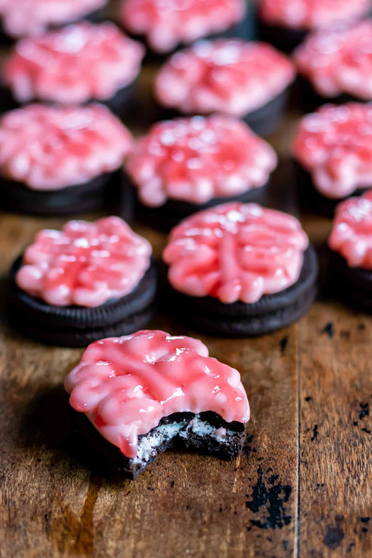 Many brain-shaped cookies lined up next to each other.