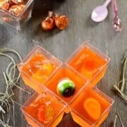 5 ghoulish cups of red jellyforming a cross shape.