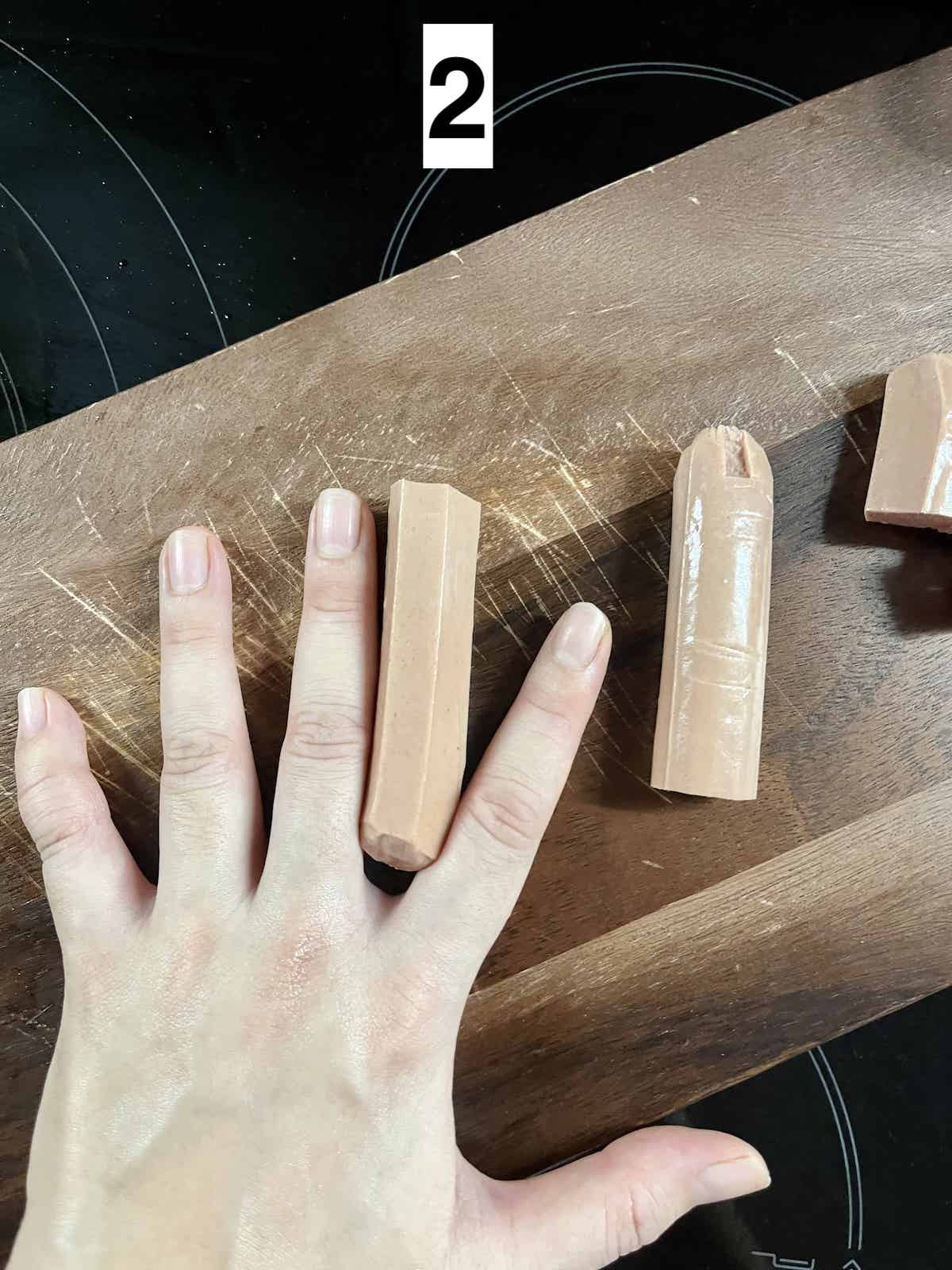 Using my fingers as a guide for how  long to make Halloween sausage fingers.