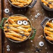 Mini pot pies that have been decorated to form mini monsters.