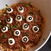 A platter full of spaghetti with creepy eyeballs on it.