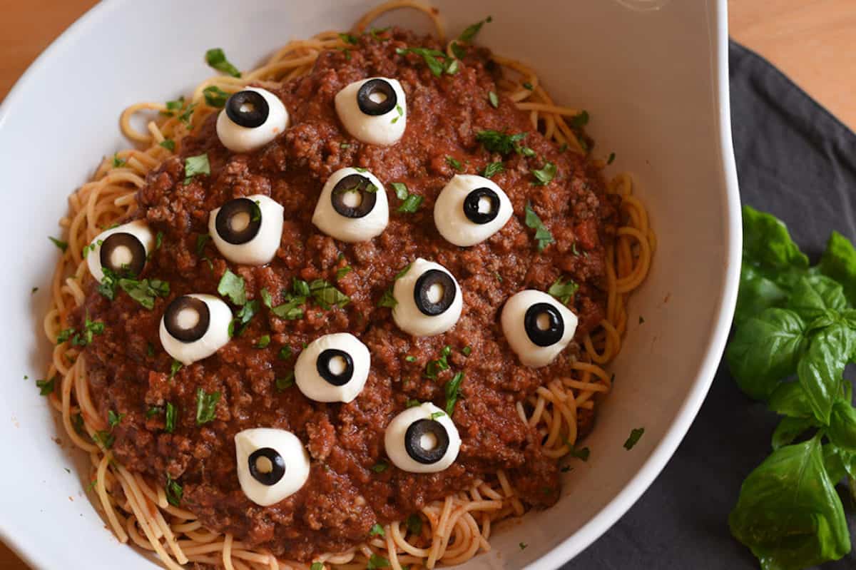 A platter full of spaghetti with creepy eyeballs on it.