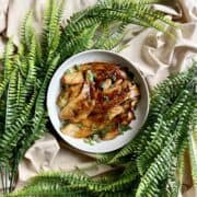 A plate of seared mushrooms tossed in a butter soy sauce.