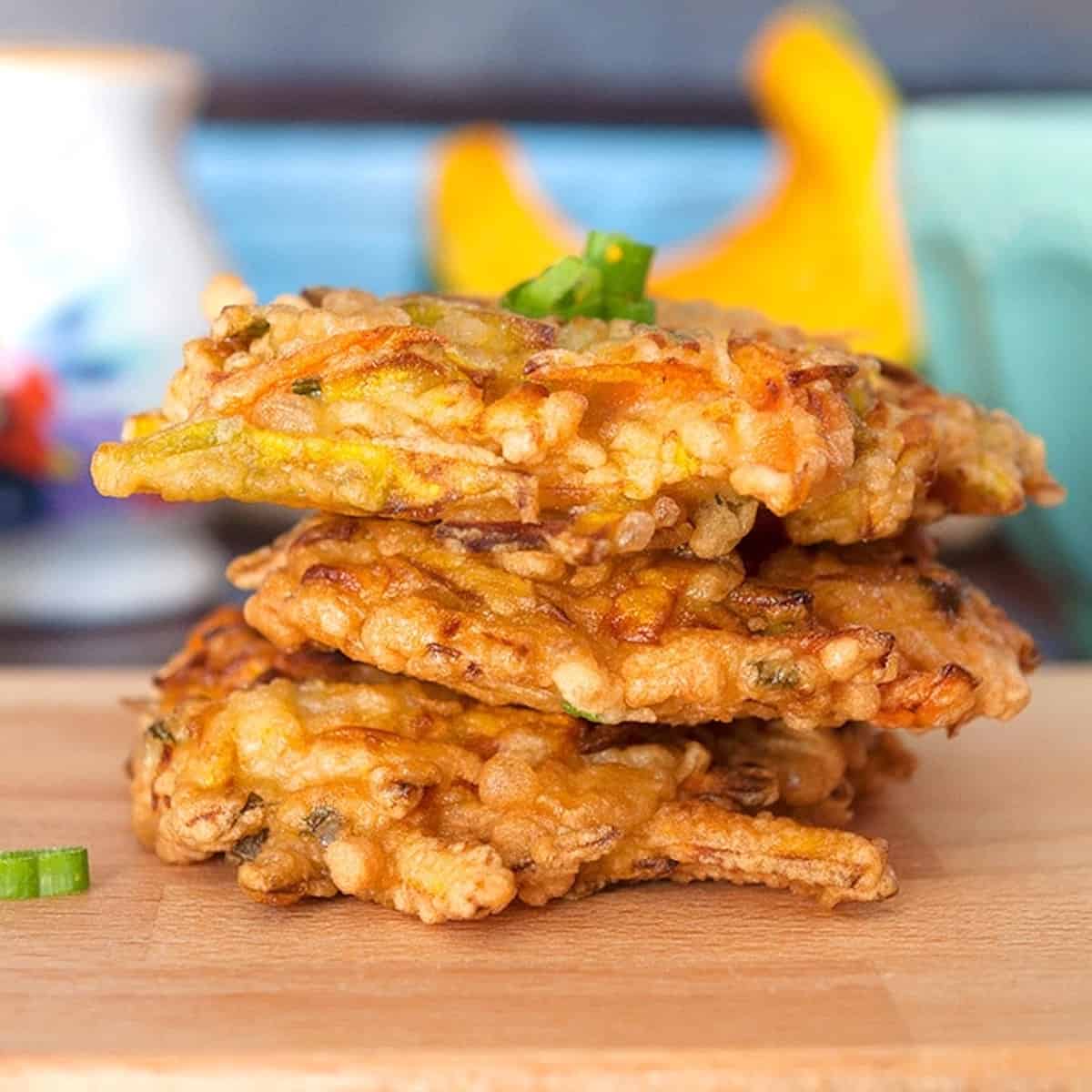 close-up of a stack of deep-fried pumpkin fritters.