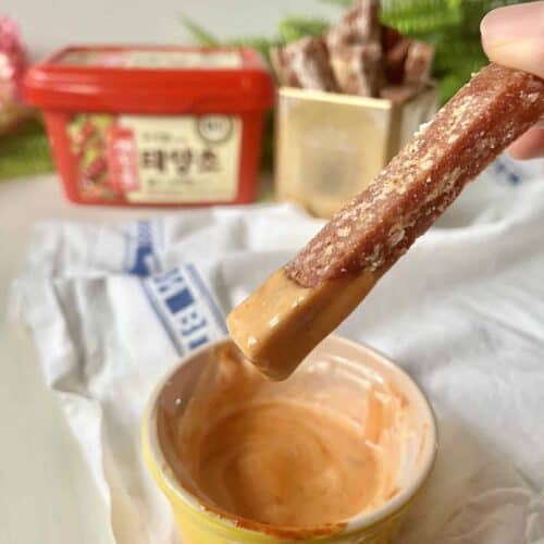 Dipping a SPAM fry into a bowl of Gochuajng Mayonnaise Sauce.