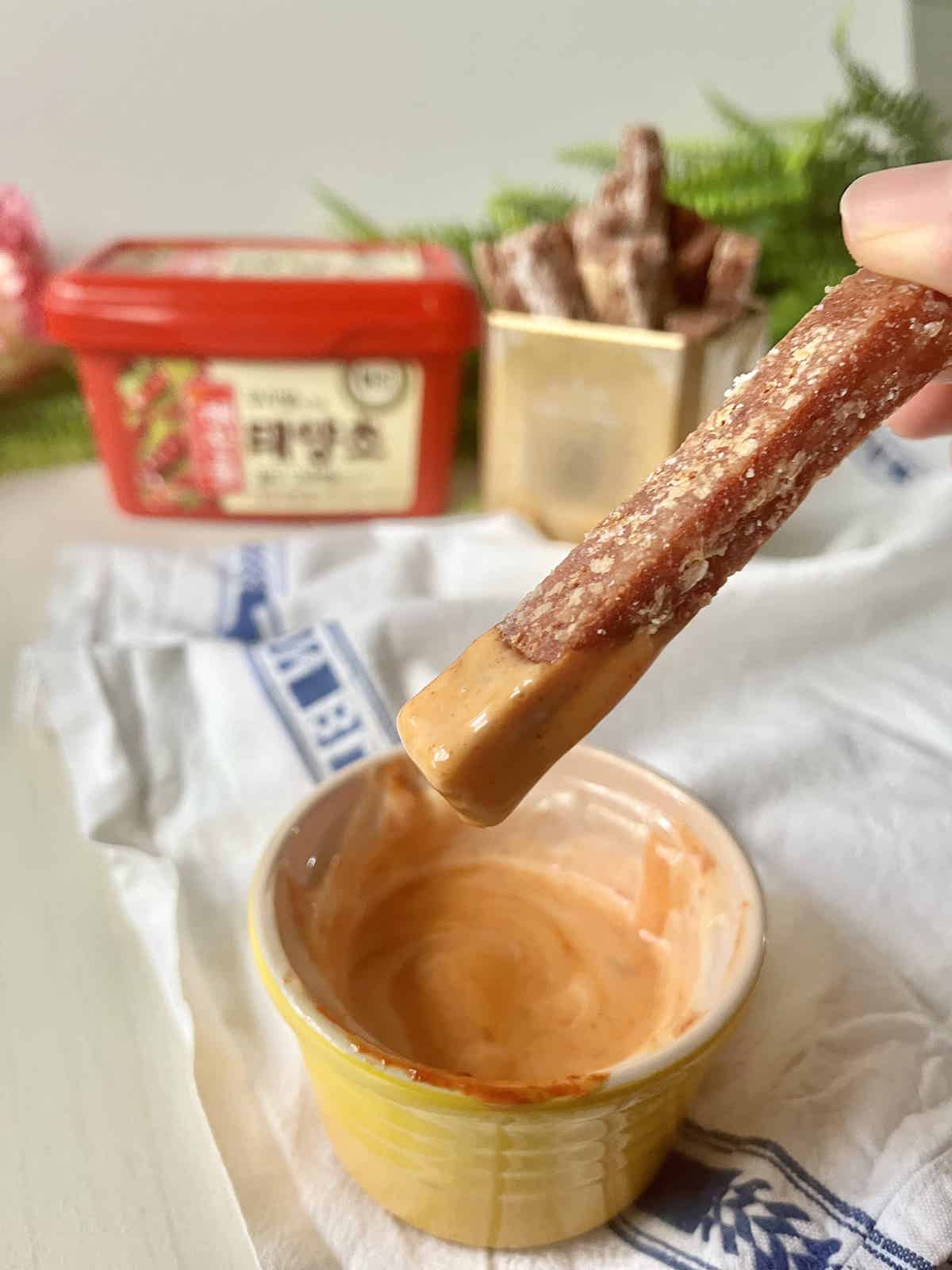 Dipping a SPAM fry into a bowl of Gochuajng Mayonnaise Sauce.