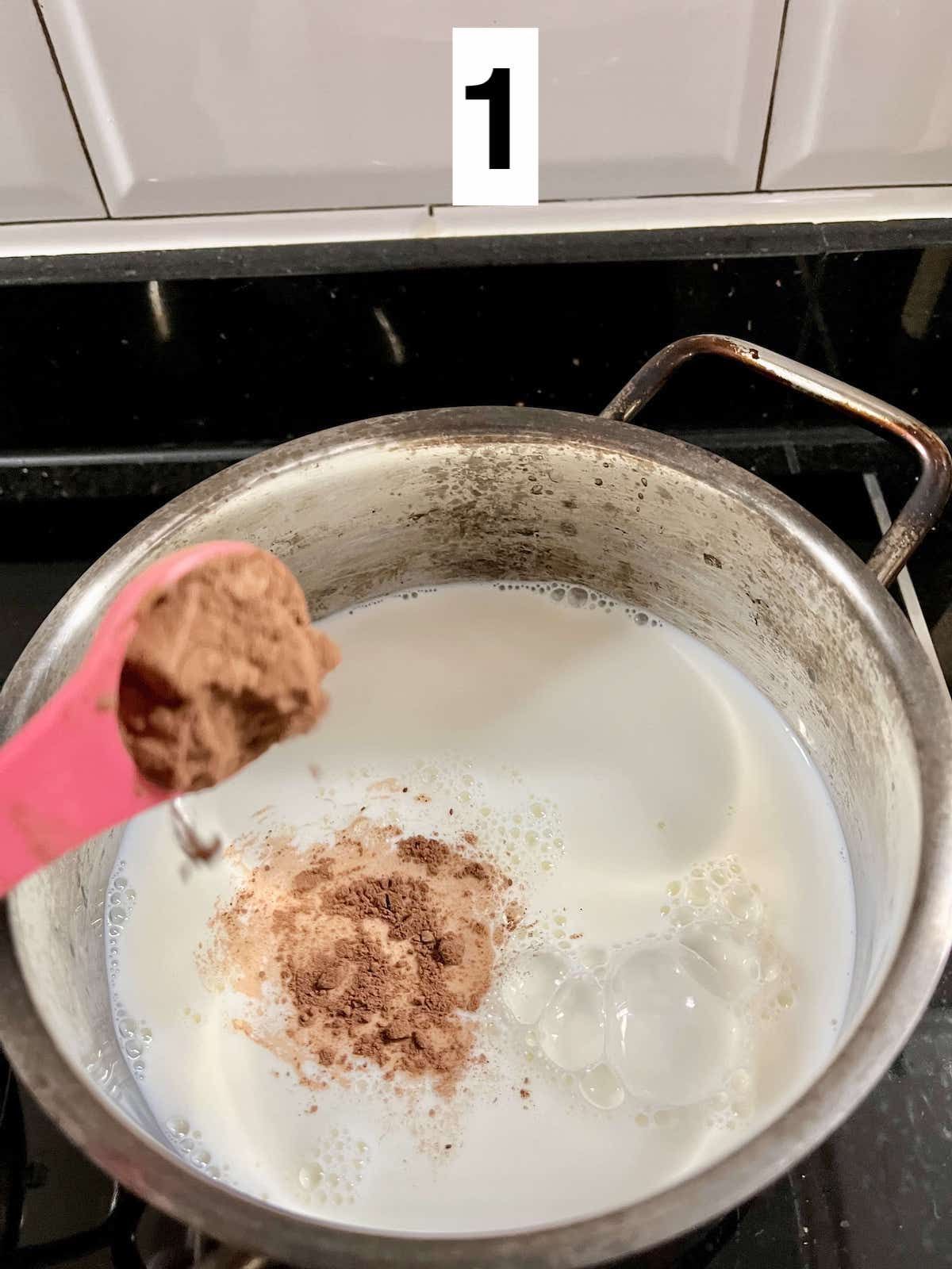 Adding cocoa powder to hot milk.