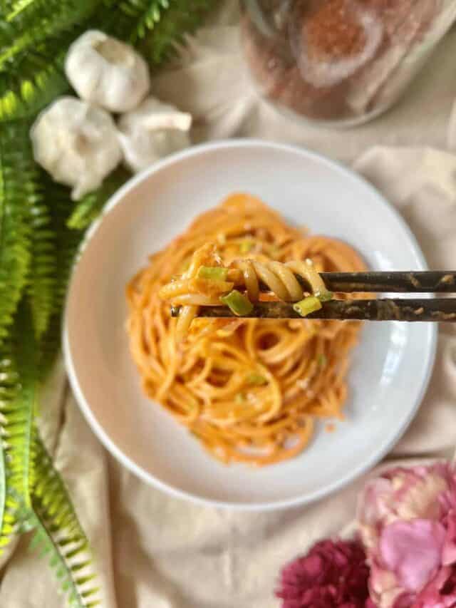 Overhead shot of gochujang pasta spaghetti on a white plate.